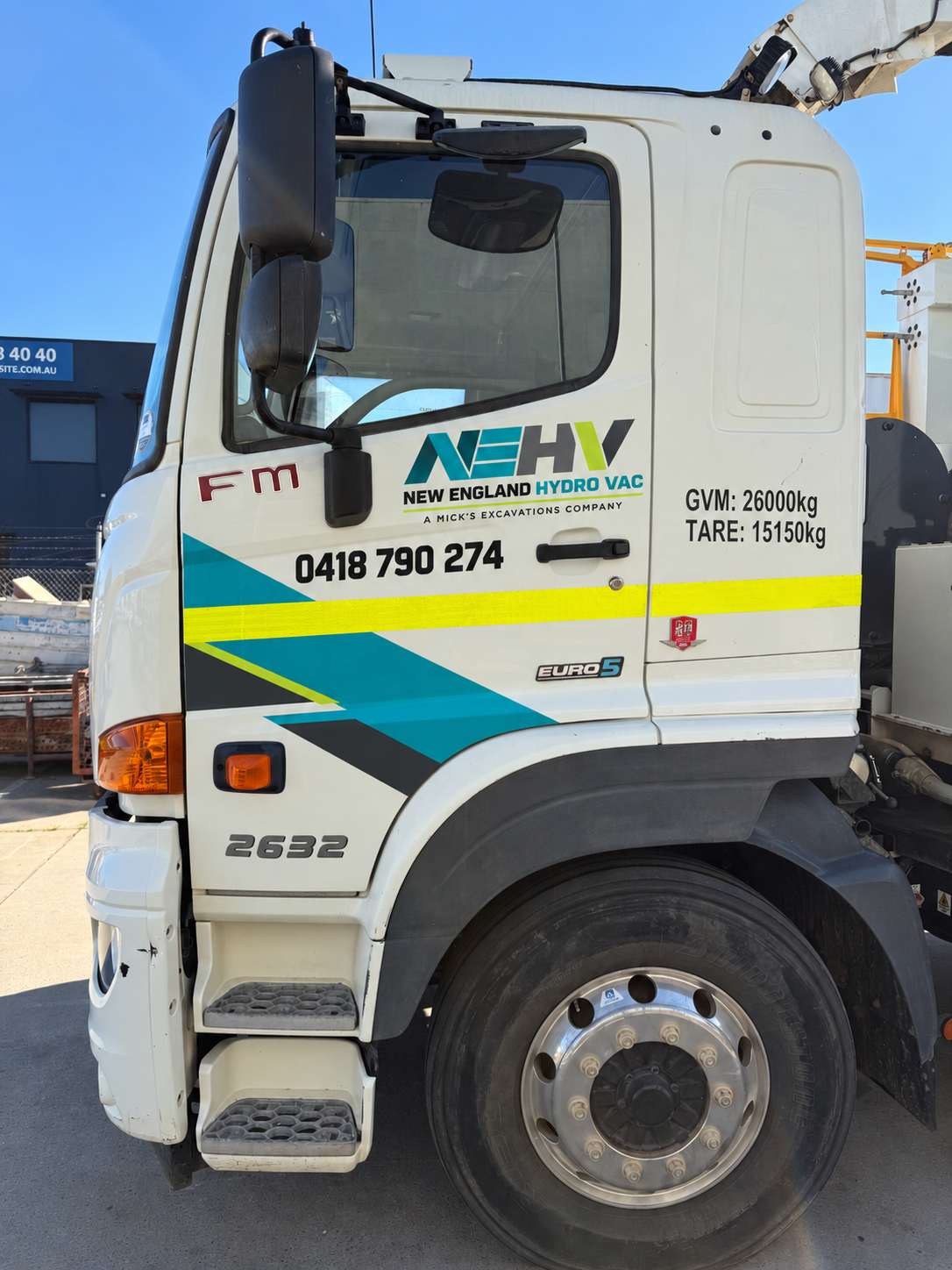 New England Hydro Vac driver cab with NEHV logo, phone 0418 790 274 and GVM specs