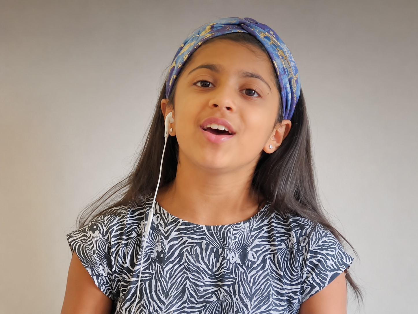 Child singing at home during an online singing lesson with Limitless Music Academy
