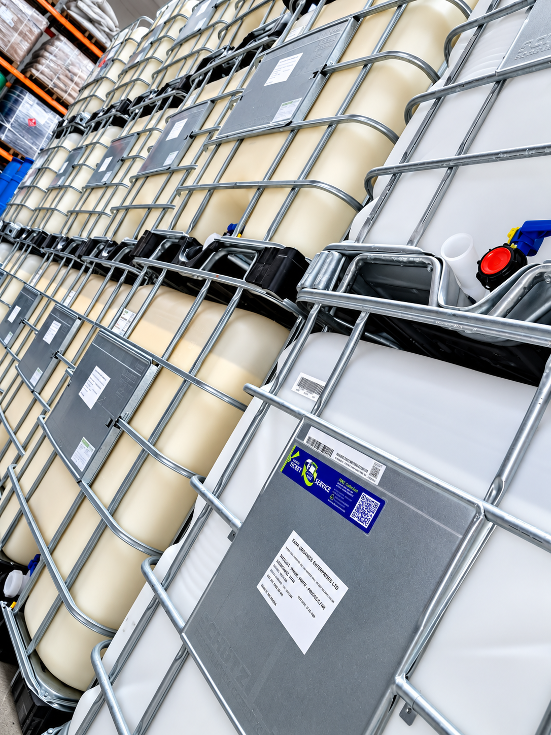 Large IBC bulk liquid containers in metal cages stored in the warehouse