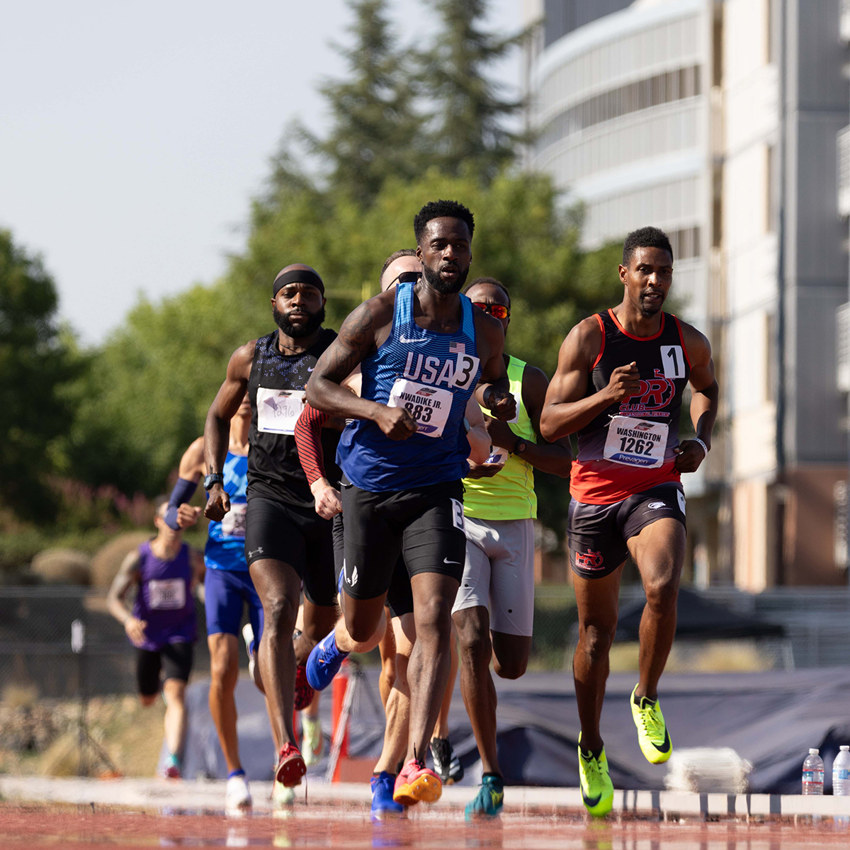 Coach Ken Nwadike Jr. competing as a Masters athlete in his USA track and field jersey