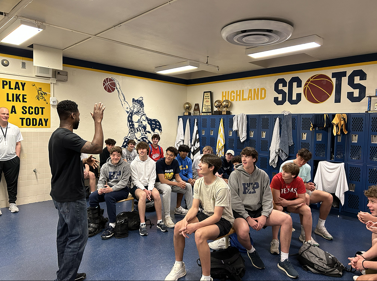 Coach Ken speaking to athletes in the team locker room