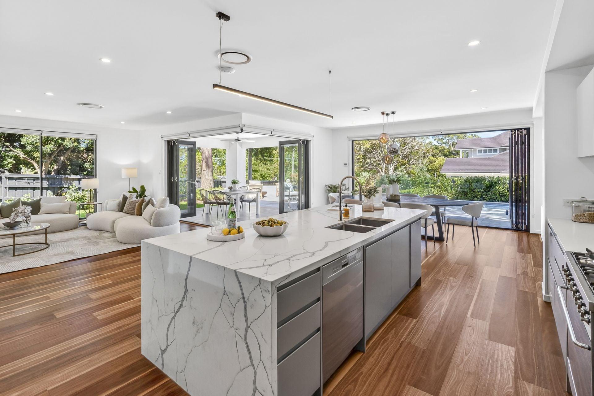 Finished luxury open-plan kitchen with marble waterfall island
