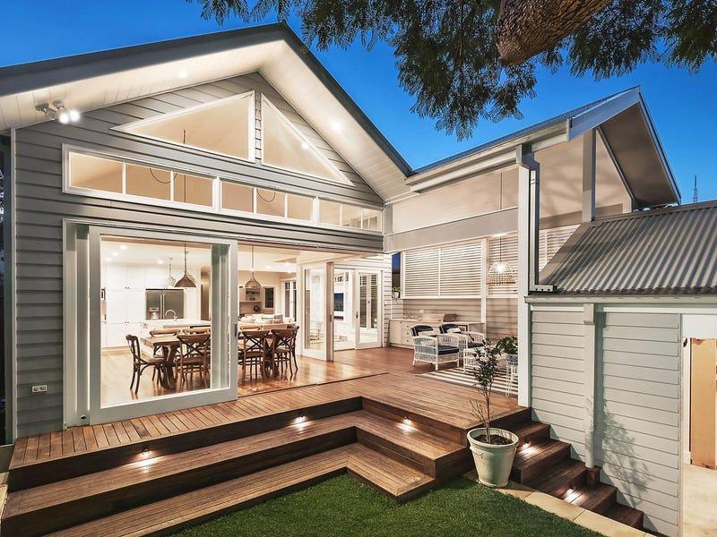 Architectural renovation with open-plan indoor-outdoor entertaining area and illuminated timber deck