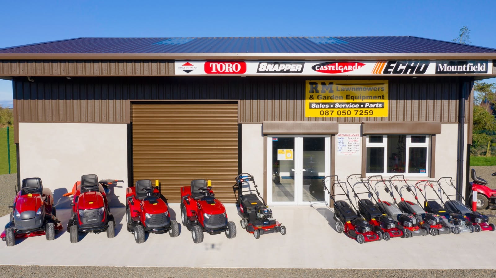 RM Lawnmowers shopfront and showroom with ride-on and push lawnmowers on display in Meath