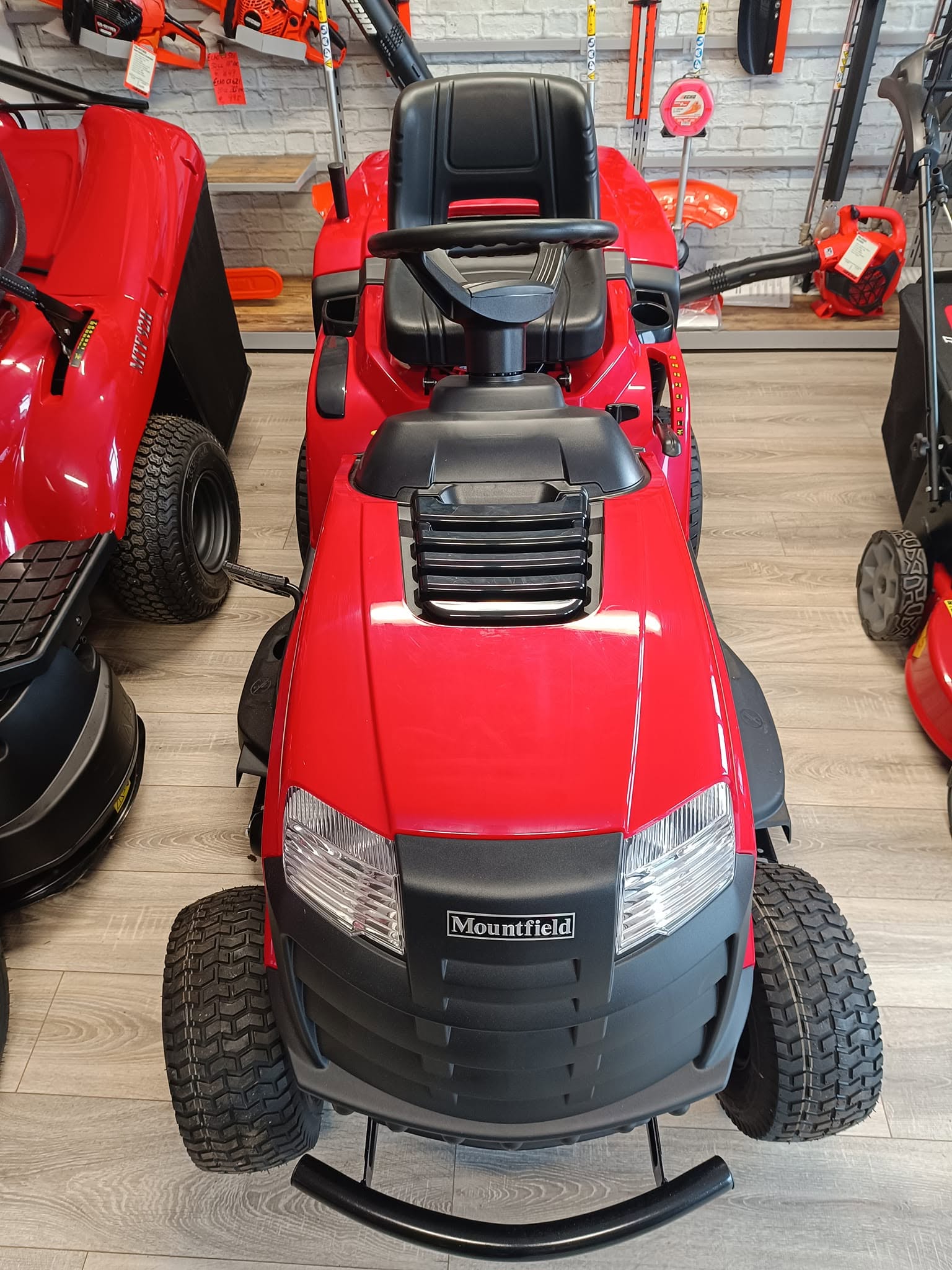 Mountfield red lawn tractor head-on view inside RM Lawnmowers showroom