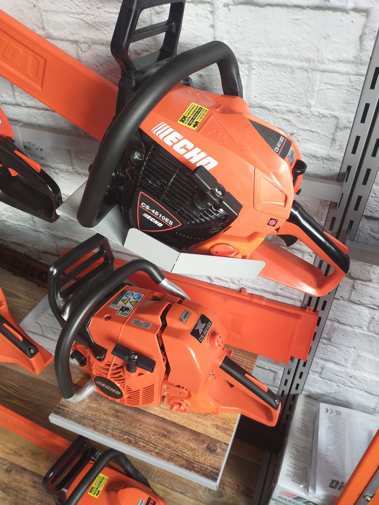 Echo CS-4510ES and CS-621SX chainsaws on display rack at RM Lawnmowers