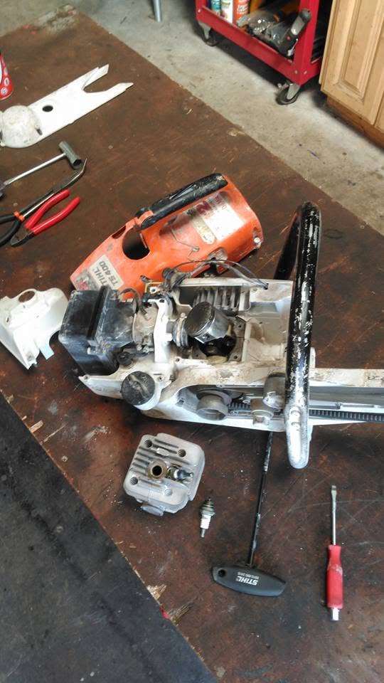 Power equipment stripped down on workshop bench for servicing and rebuild