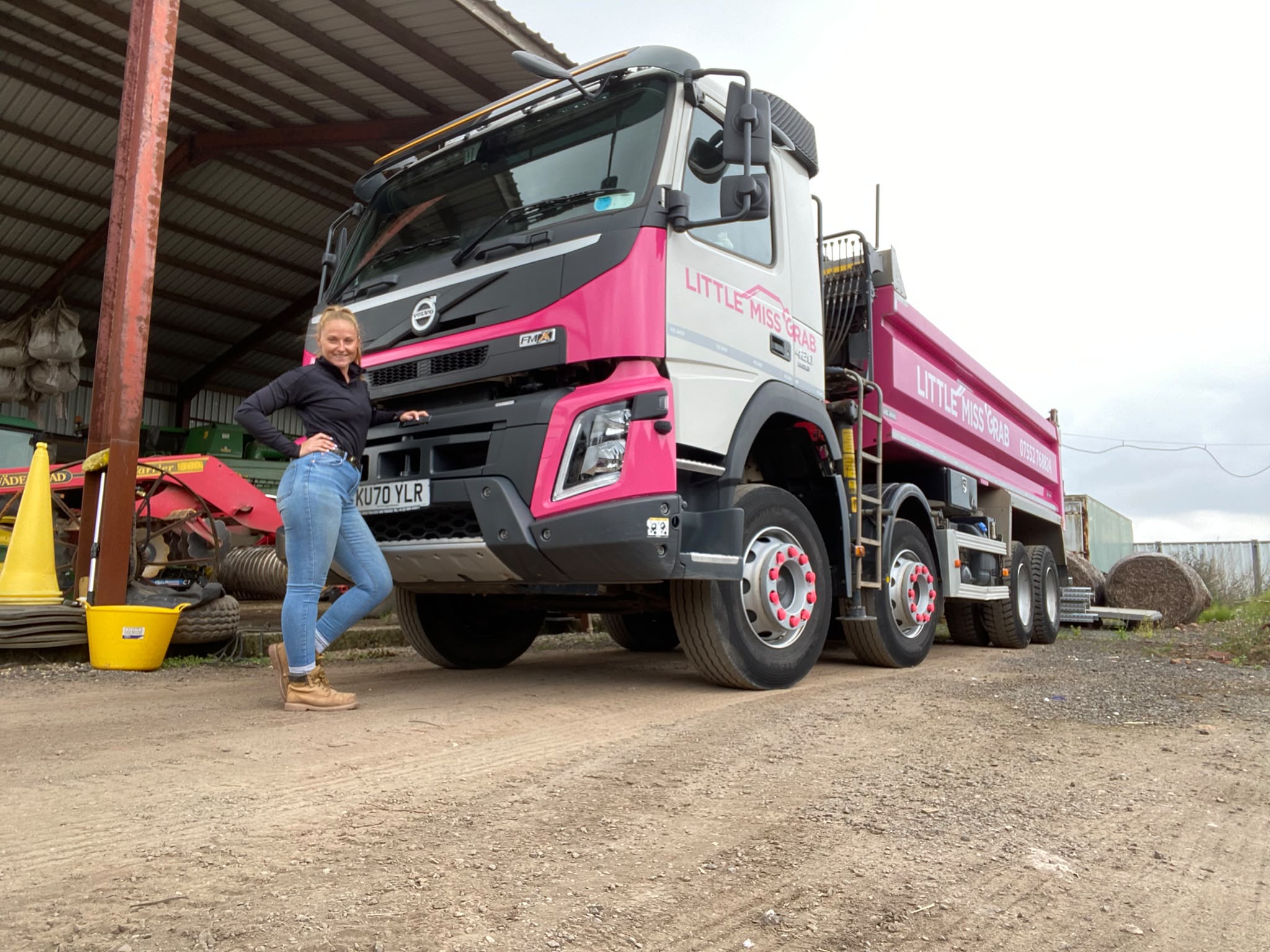 Little Miss Grab branded pink Volvo FMX 8-wheel grab lorry with driver