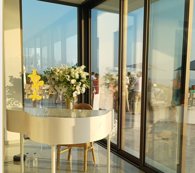 White baby grand piano set up for a wedding ceremony performance — photo 1