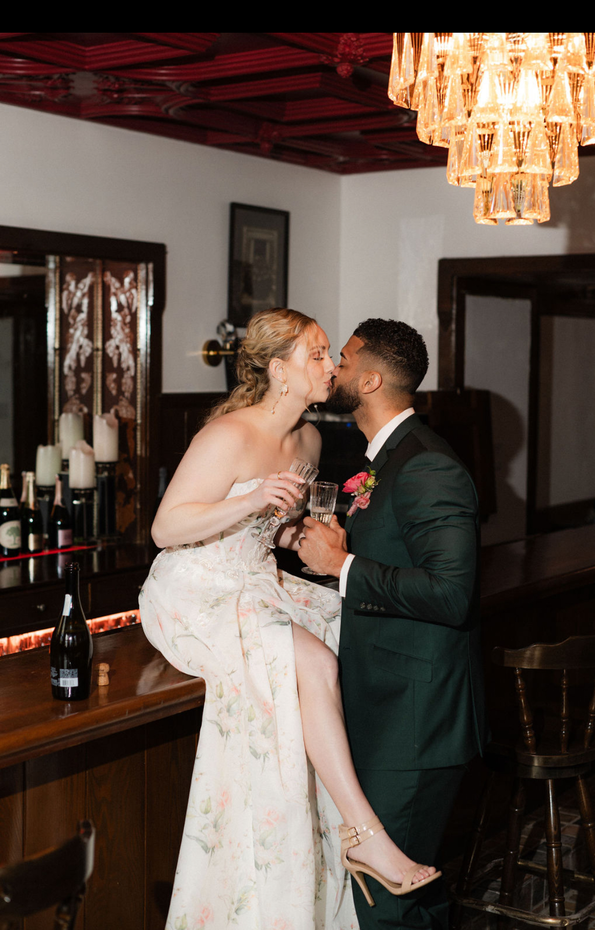 Couple kissing under the chandelier