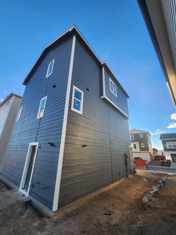 Three-Story Charcoal Horizontal Siding & Crisp White Trim