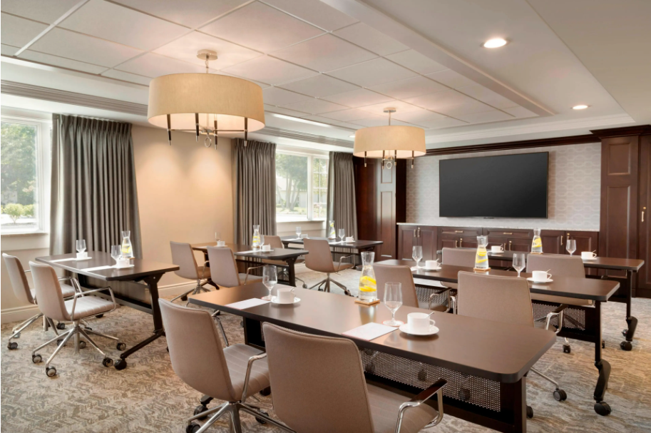Reikart House executive classroom and event meeting space with boardroom seating and screens