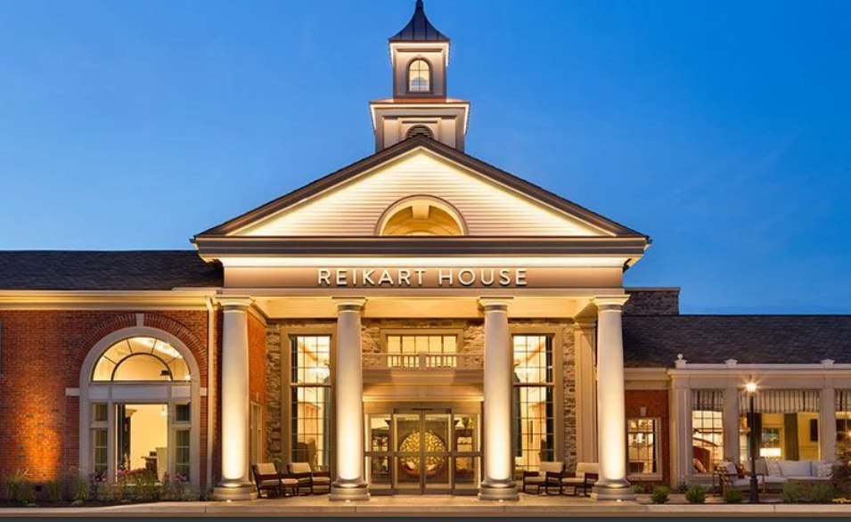 Exterior facade of Reikart House hotel in Amherst NY with illuminated cupola at dusk