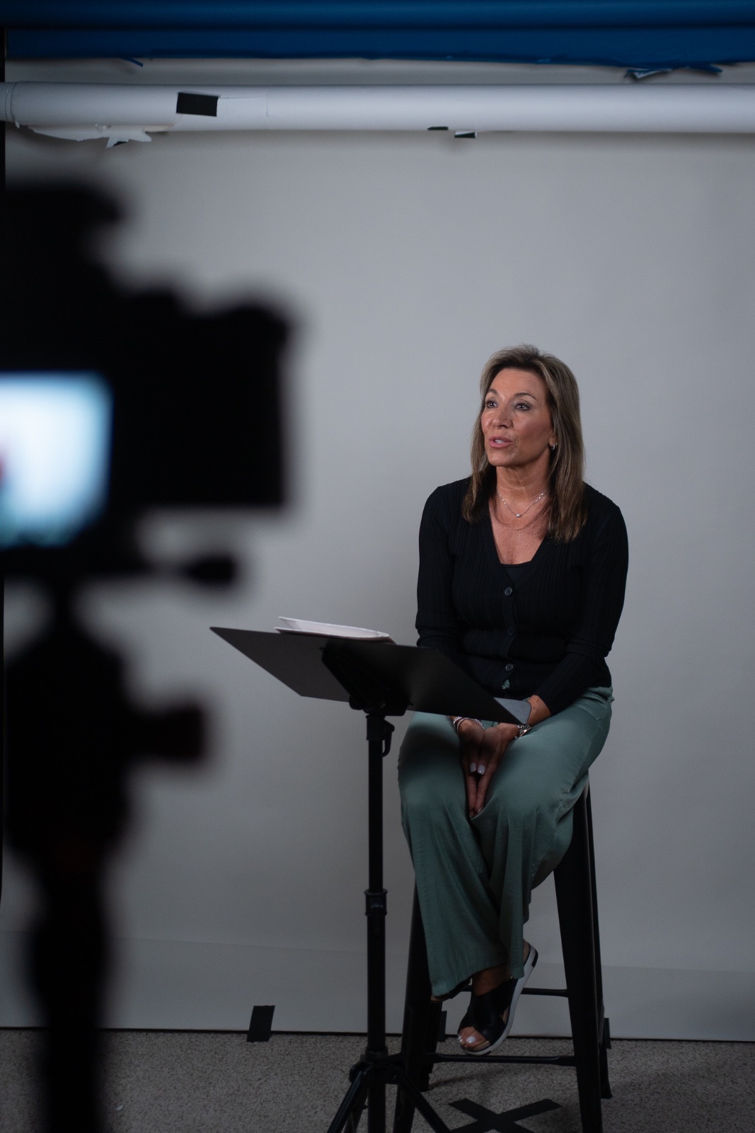 Lori speaking in a studio interview