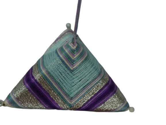 Close-up detail of geometric thread-wrapped pyramid ornament showing crisp chevron tension, metallic thread, and corner pins