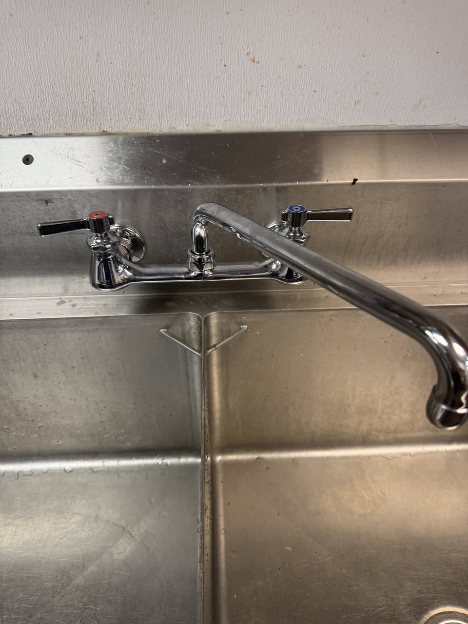 Wall-mounted faucet replacement on a two-compartment commercial sink in Johnson City, TN