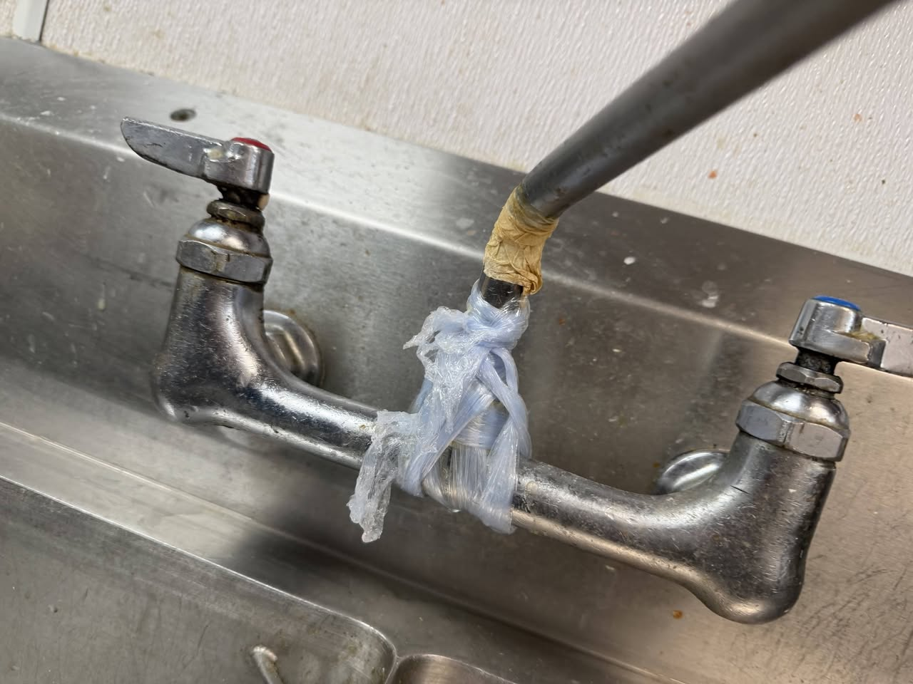 Wall-mounted faucet replacement on a two-compartment commercial sink in Johnson City, TN