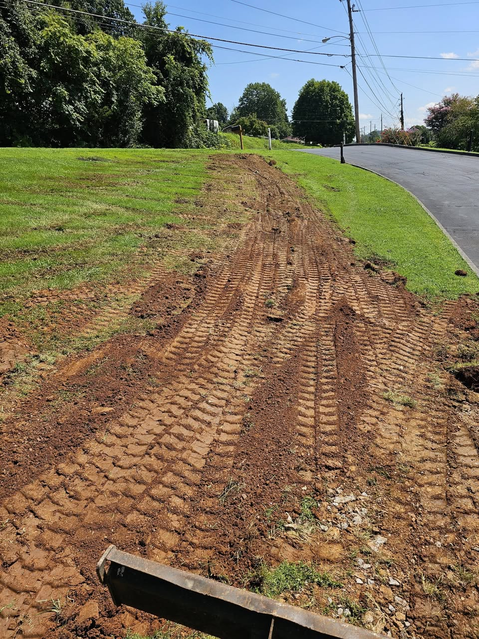 Graded and backfilled lawn after water line installation at Emmaus Church in Kingsport, TN