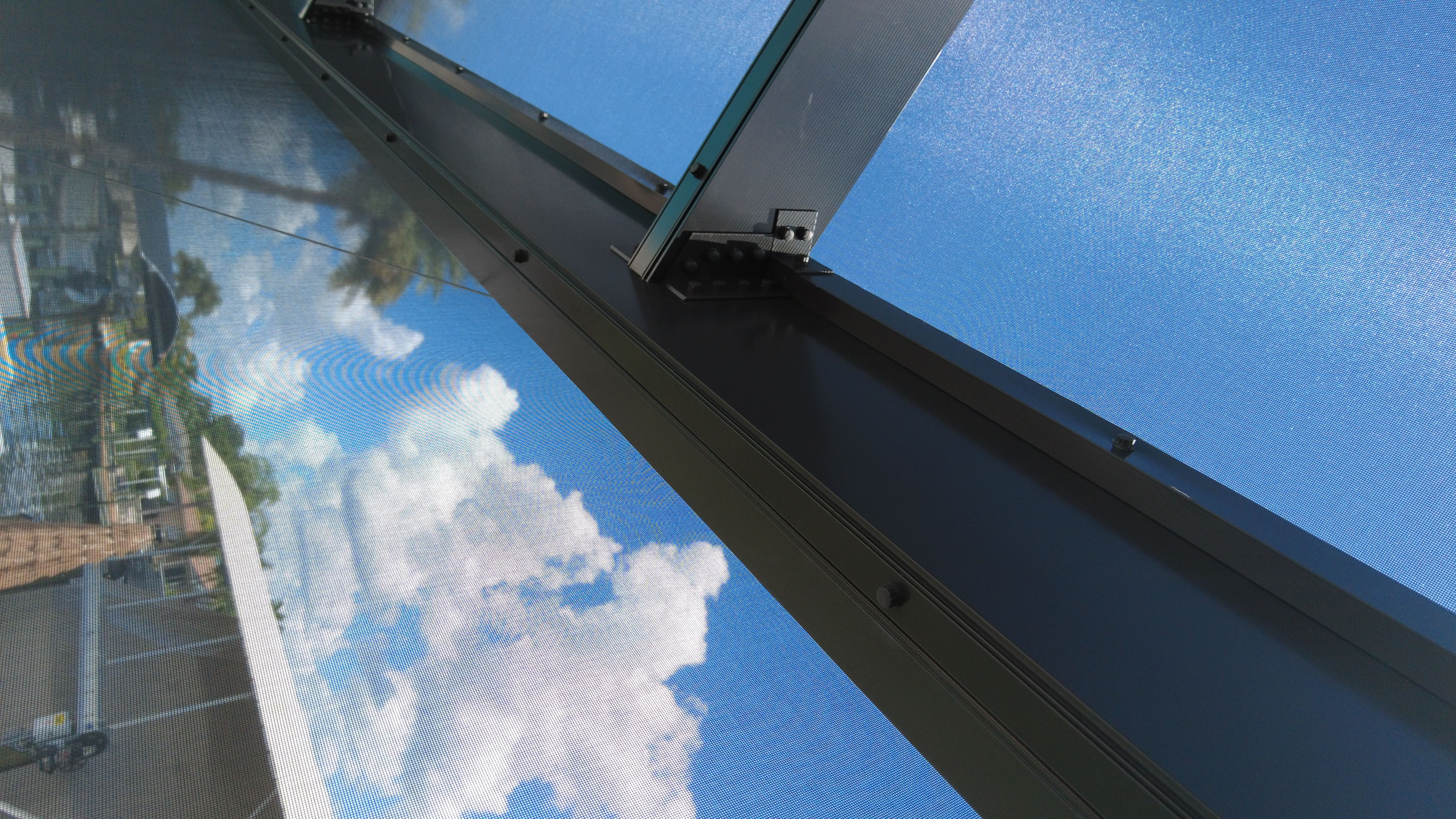 Close-up of bolted structural aluminum gusset and reinforced frame on an Excel Exteriors pool enclosure