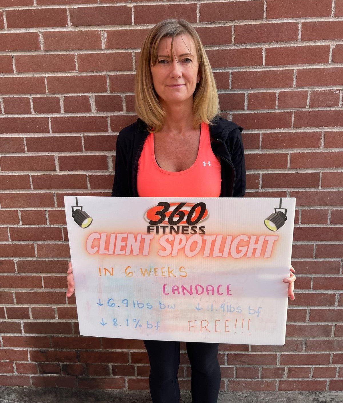 Candace, 51, member of 360 Fitness Red Deer holding her 6-week spotlight board