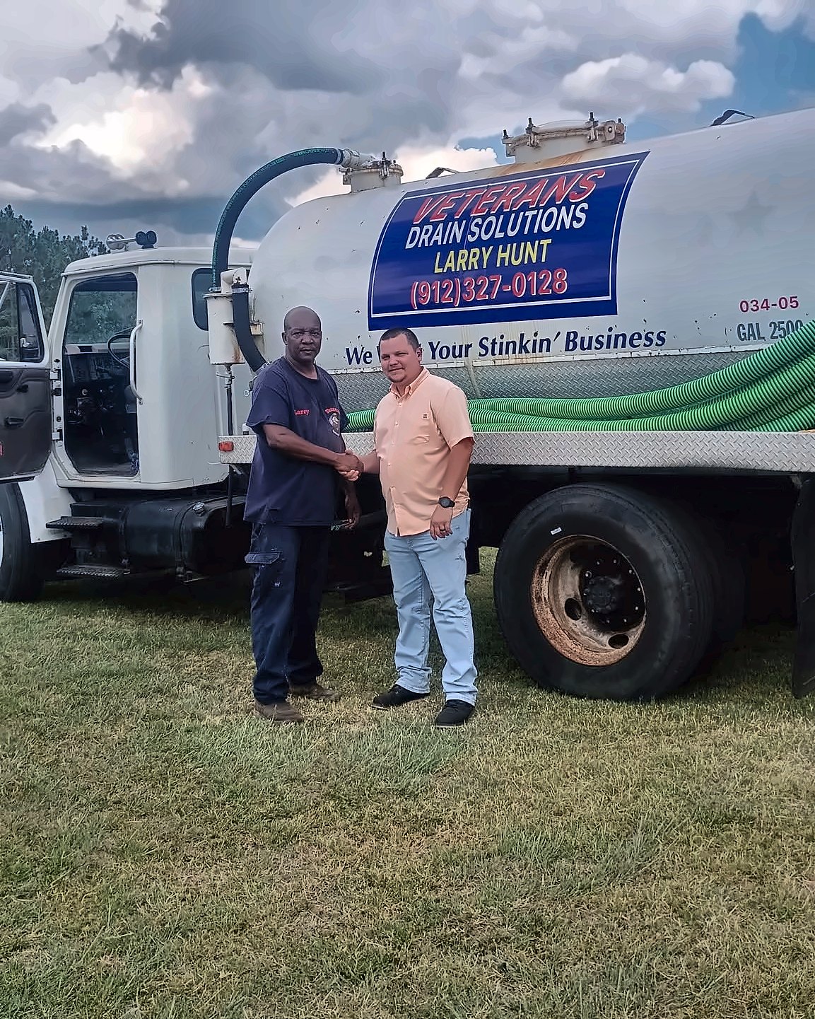 Larry Hunt with a local customer at the service truck