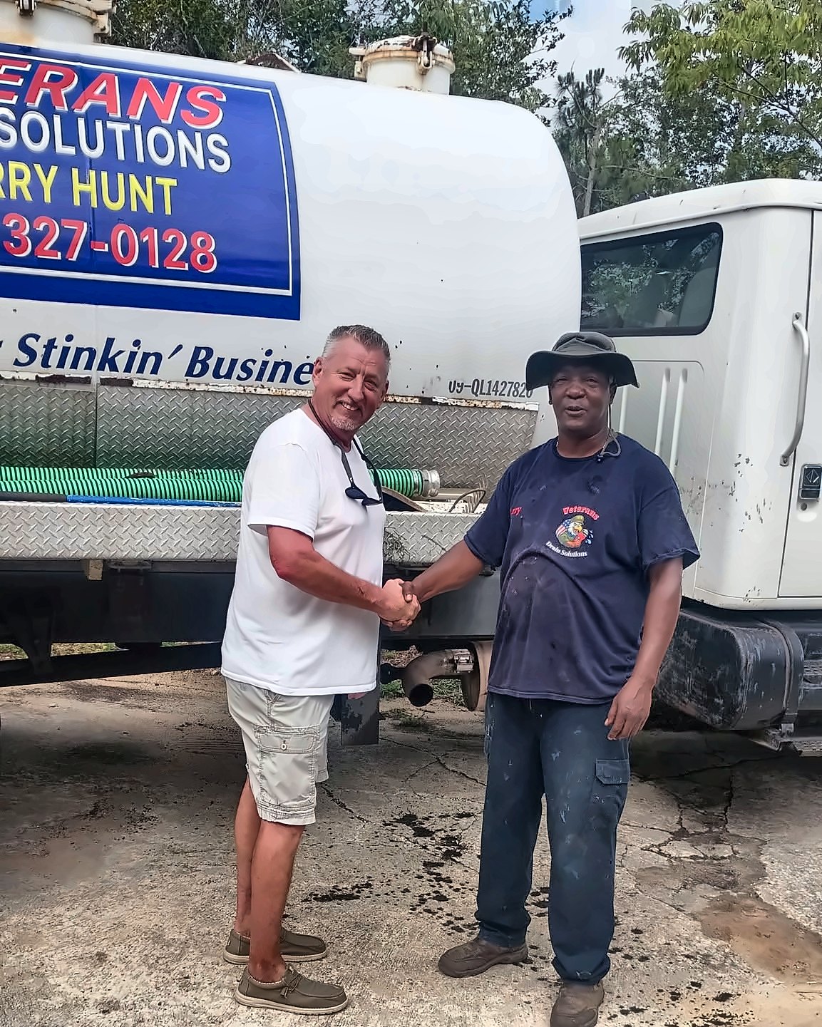 Larry Hunt on site with a customer at the Veterans Drain Solutions service truck