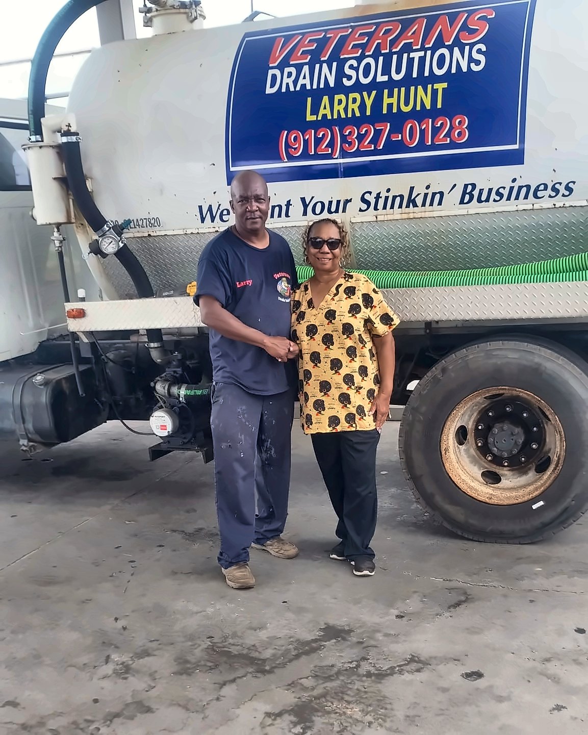 Larry Hunt with a customer next to the Veterans Drain Solutions truck