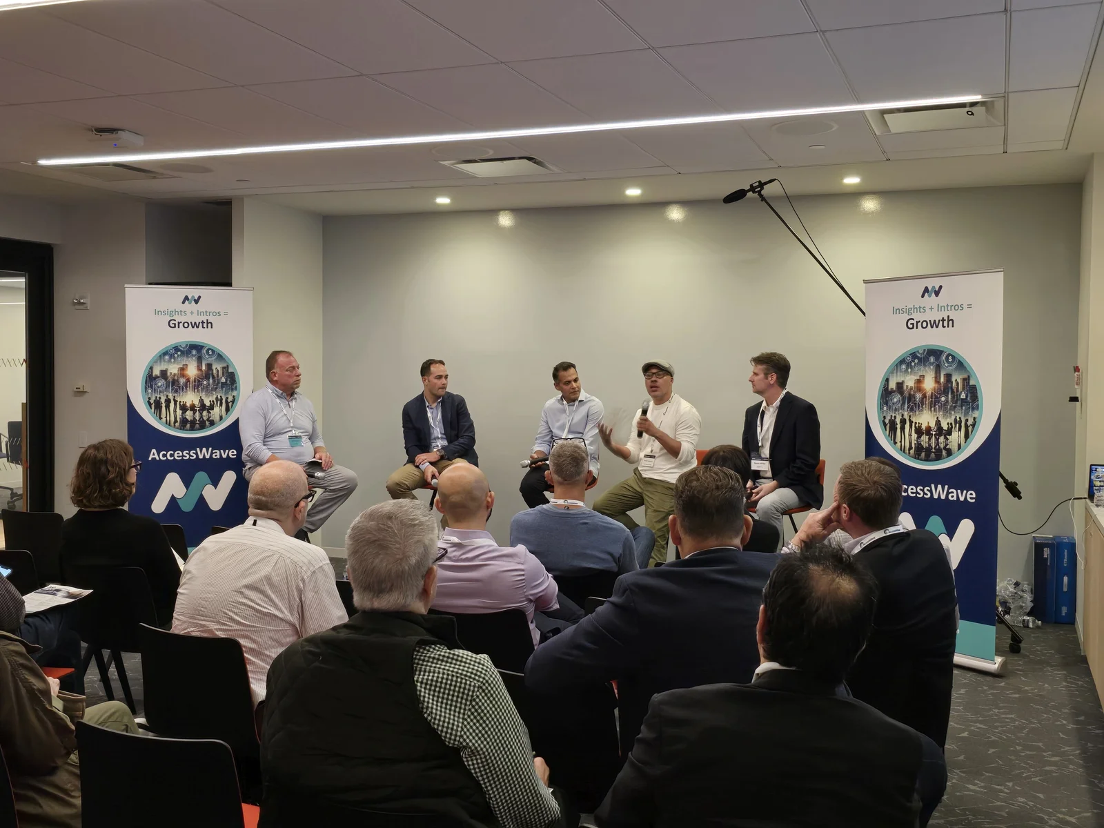 Daniel speaking into a microphone during a business panel discussion