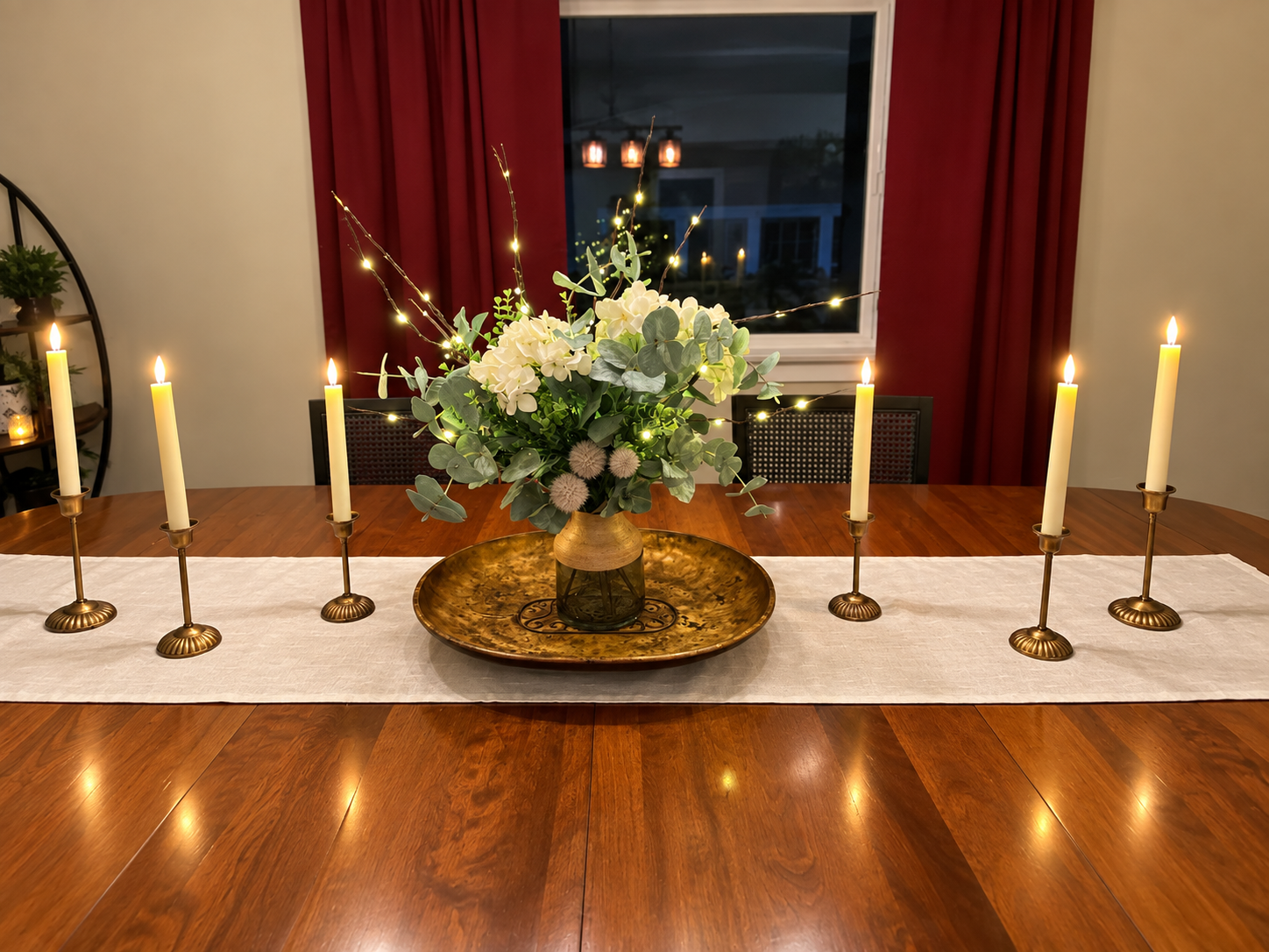 Intimate candlelit dining table setting with warm floral centerpiece