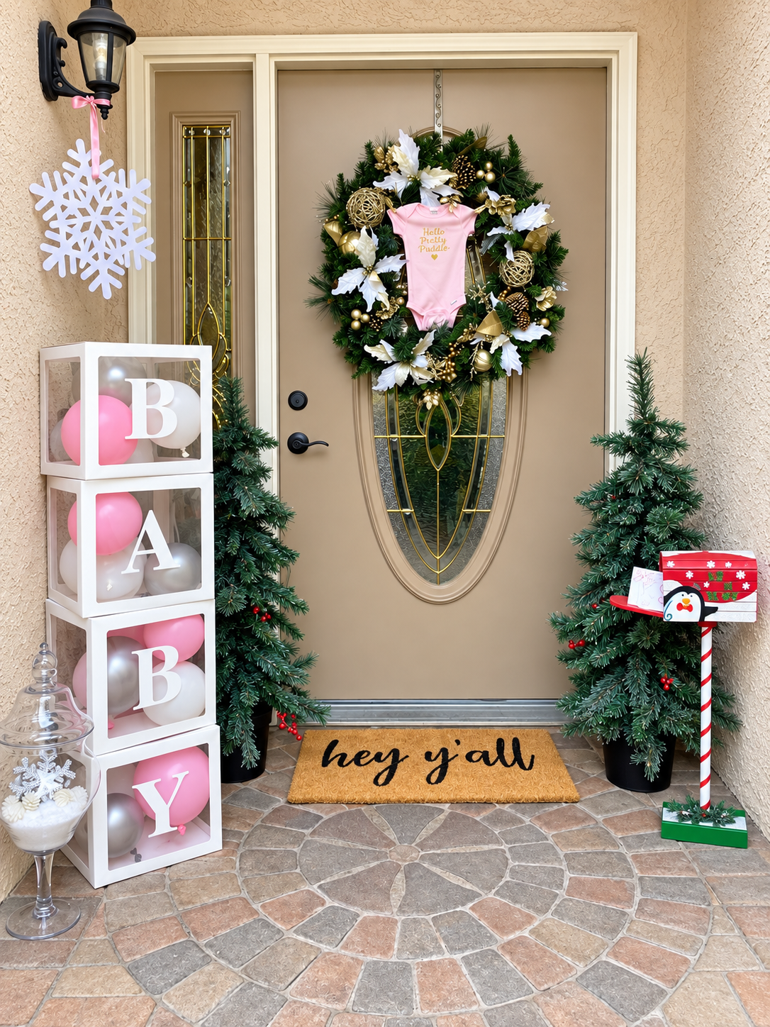 Festive baby shower entrance welcome display with balloon boxes and holiday wreath
