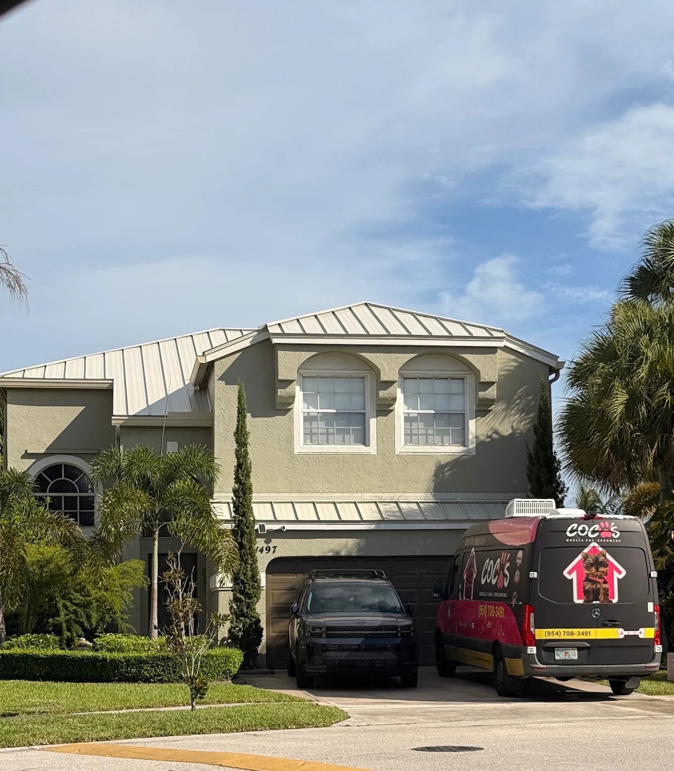 Coco's mobile grooming van parked outside a home