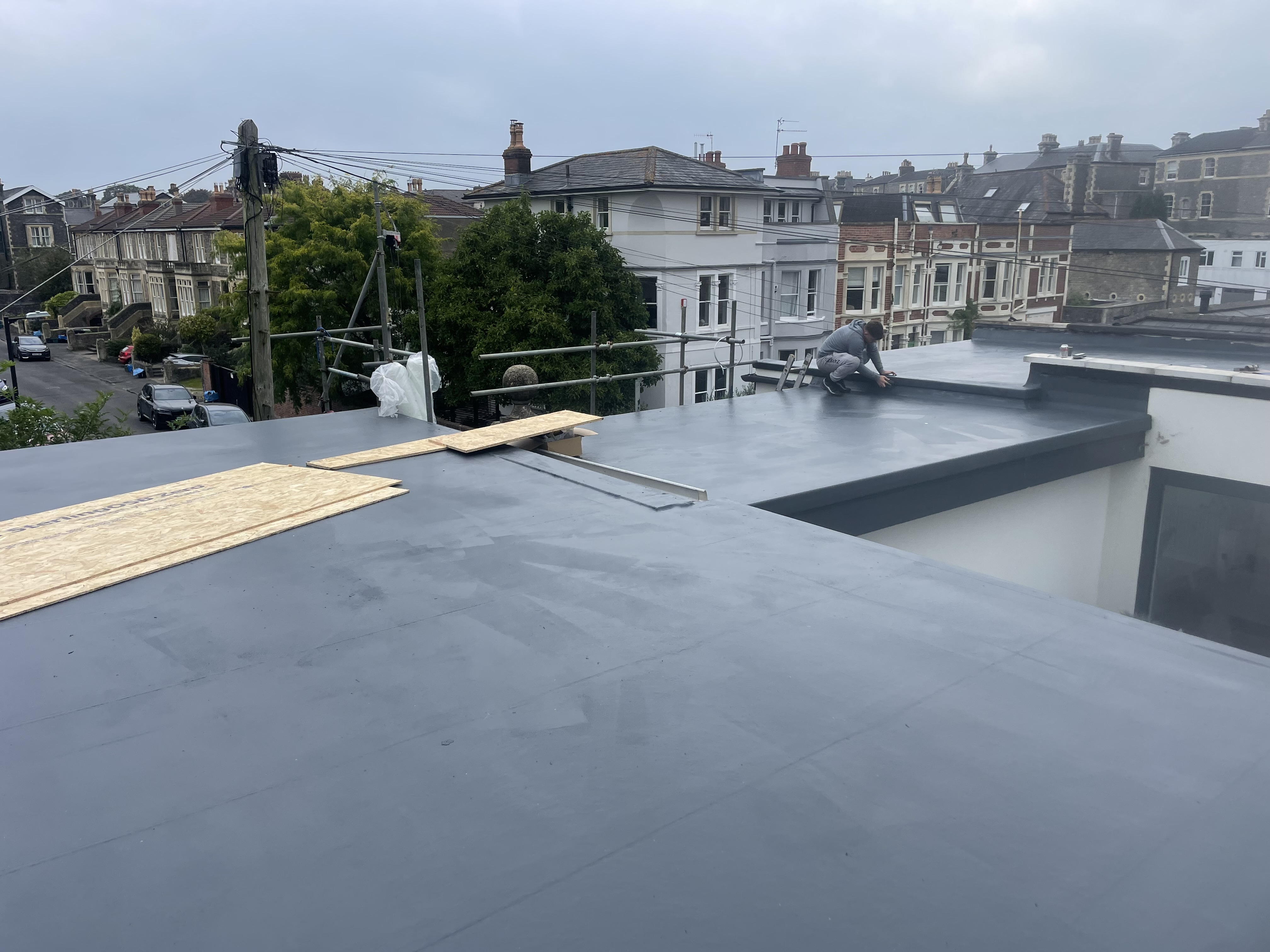 During: Sonny and the S.A.G team laying the seamless GRP resin matrix and detailing perimeter upstands across Bristol roof deck.