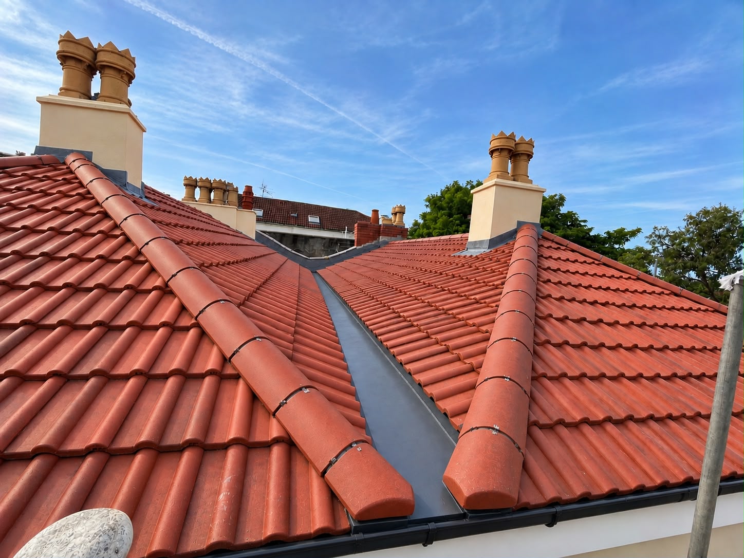 Completed hip re-roof with new profiled tiles by S.A.G Roofing Bristol