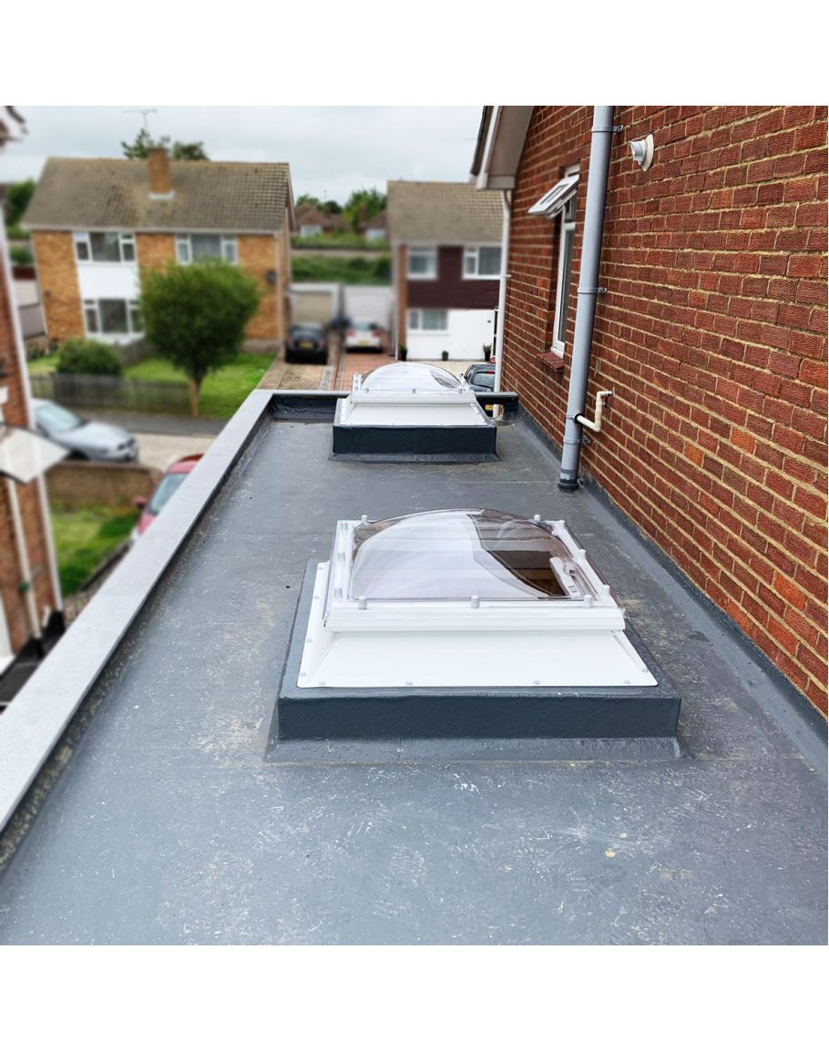 Completed: Clean GRP flat roof finish with twin domed skylights and watertight upstand flashing details.
