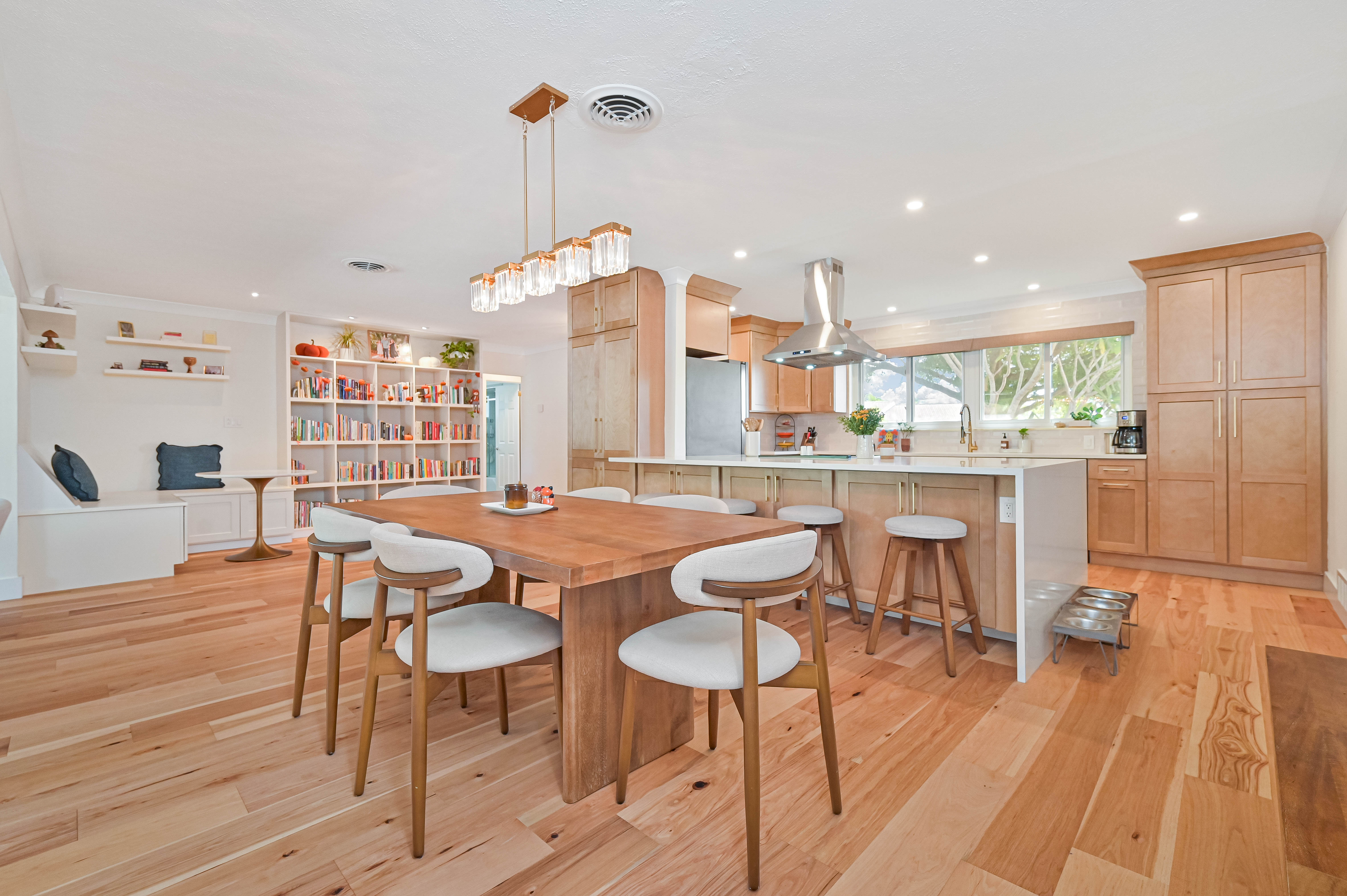 Schooner Bay Builders completed open concept kitchen and dining room transformation with warm wood floors