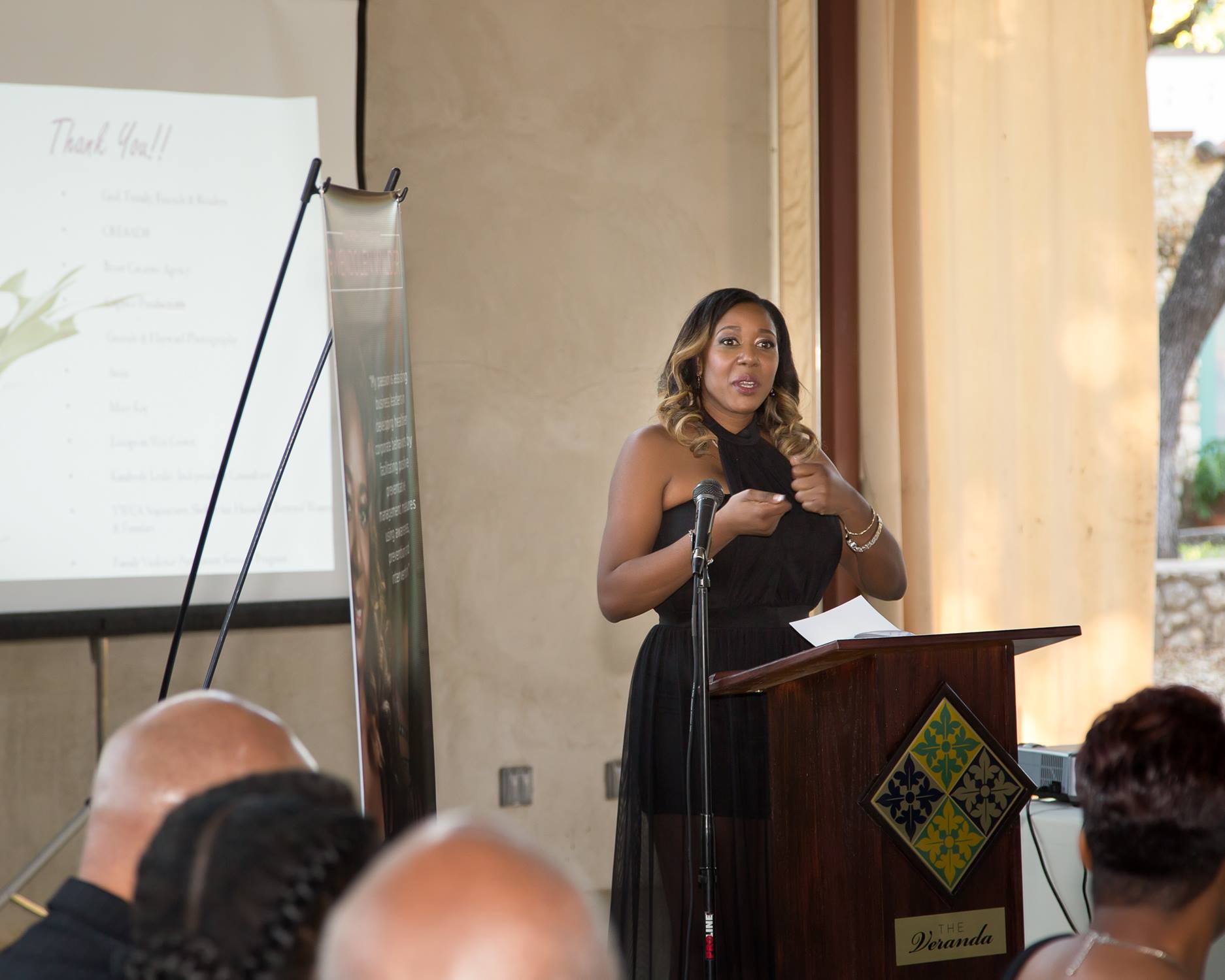Gwendolen Wilder speaking at the podium at The Veranda