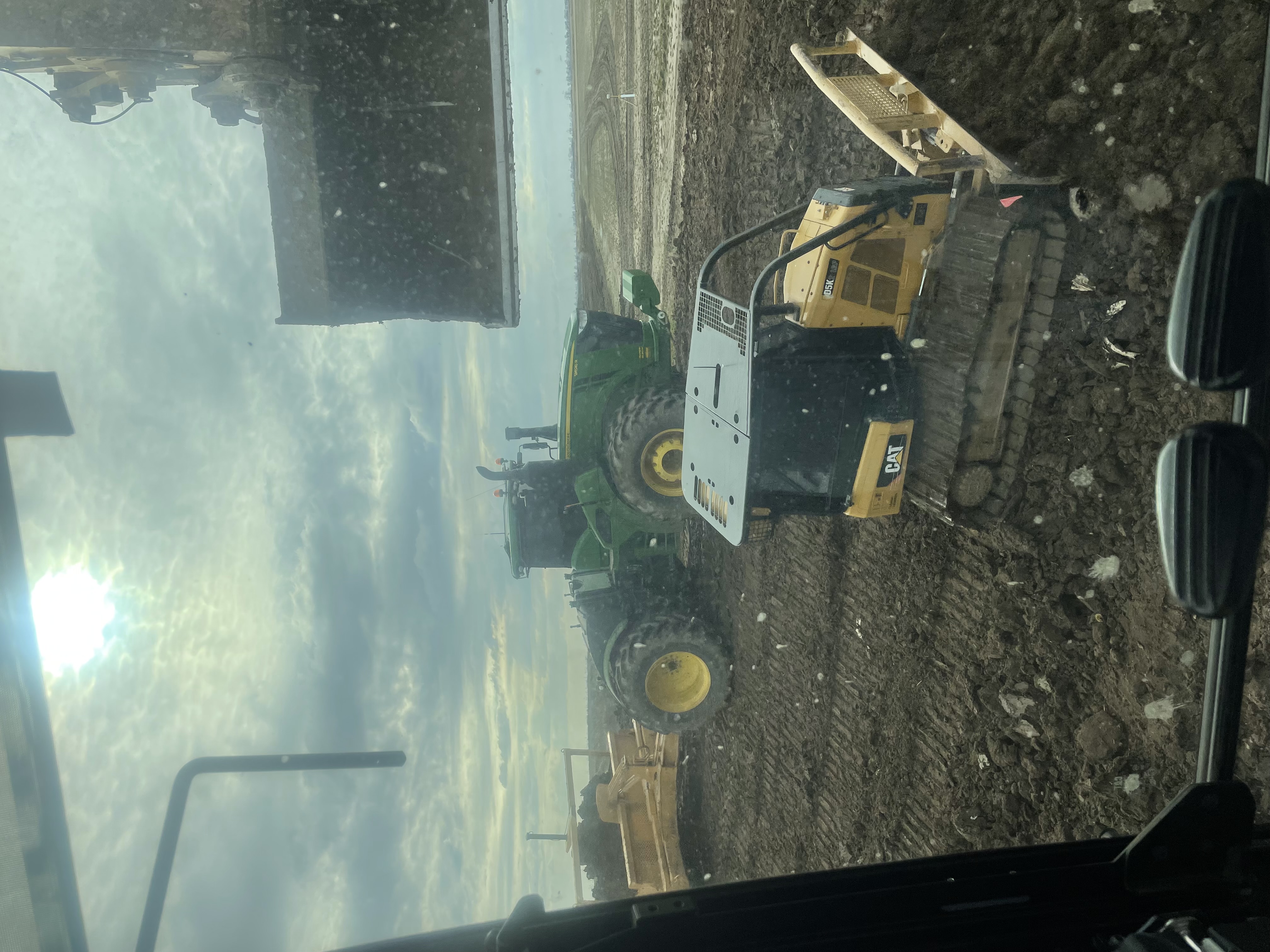 Cab-view precision grading and land shaping with CAT dozer and Deere tractor
