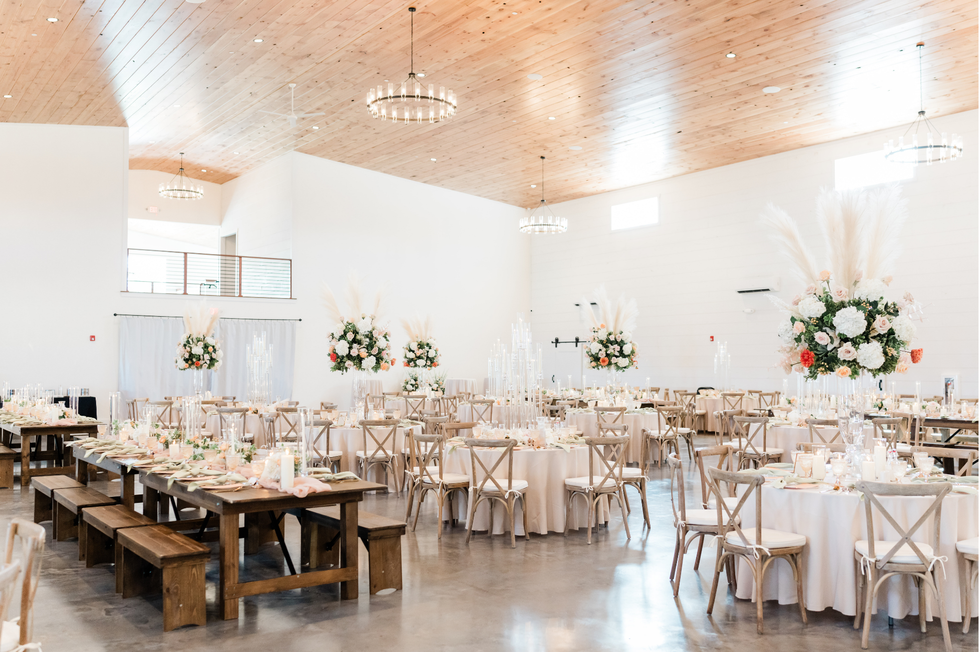Spacious grand ballroom at The Willow with high vaulted wood ceilings and round banquet tables