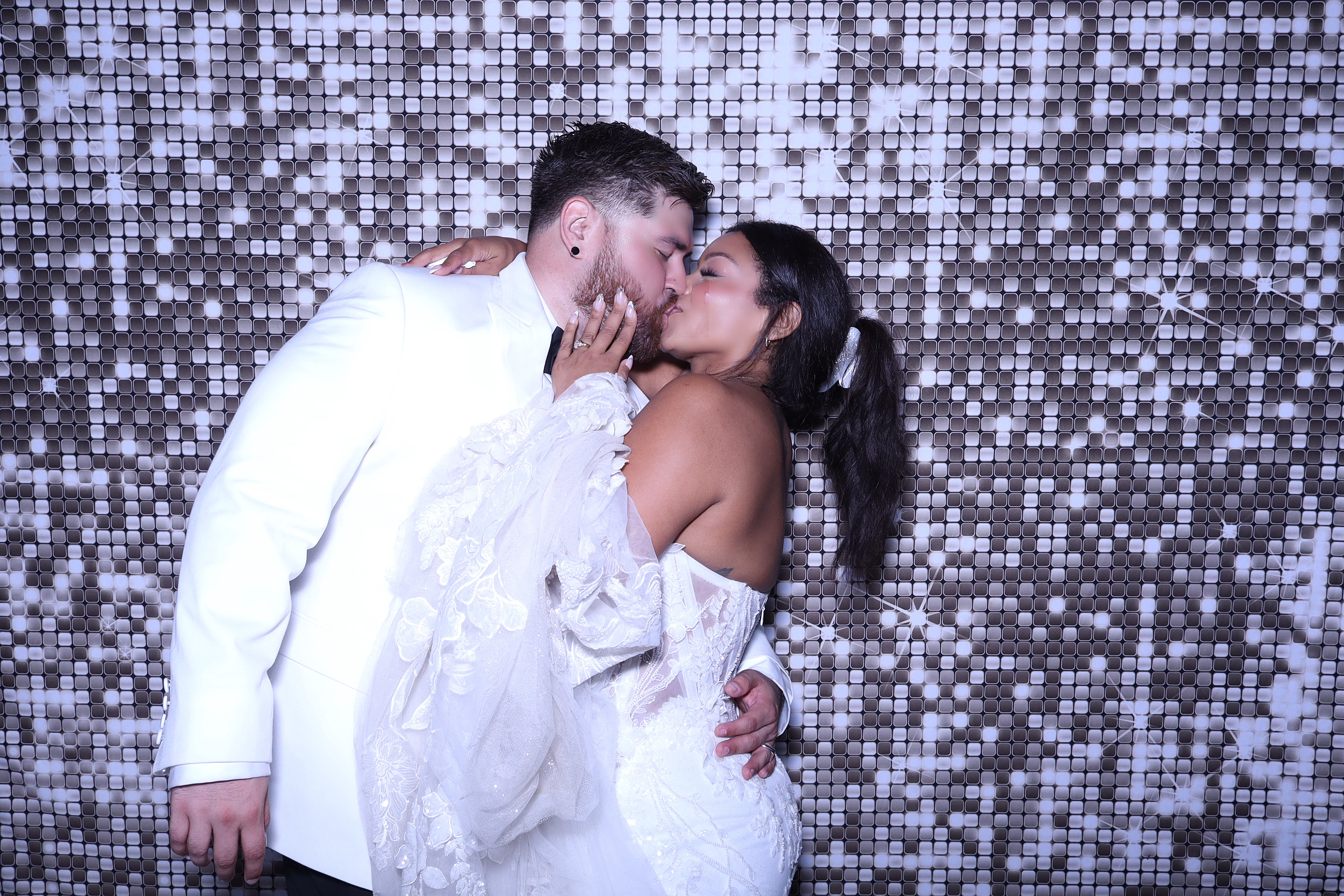 Bride and groom celebrating in a PhotoBoo photo booth
