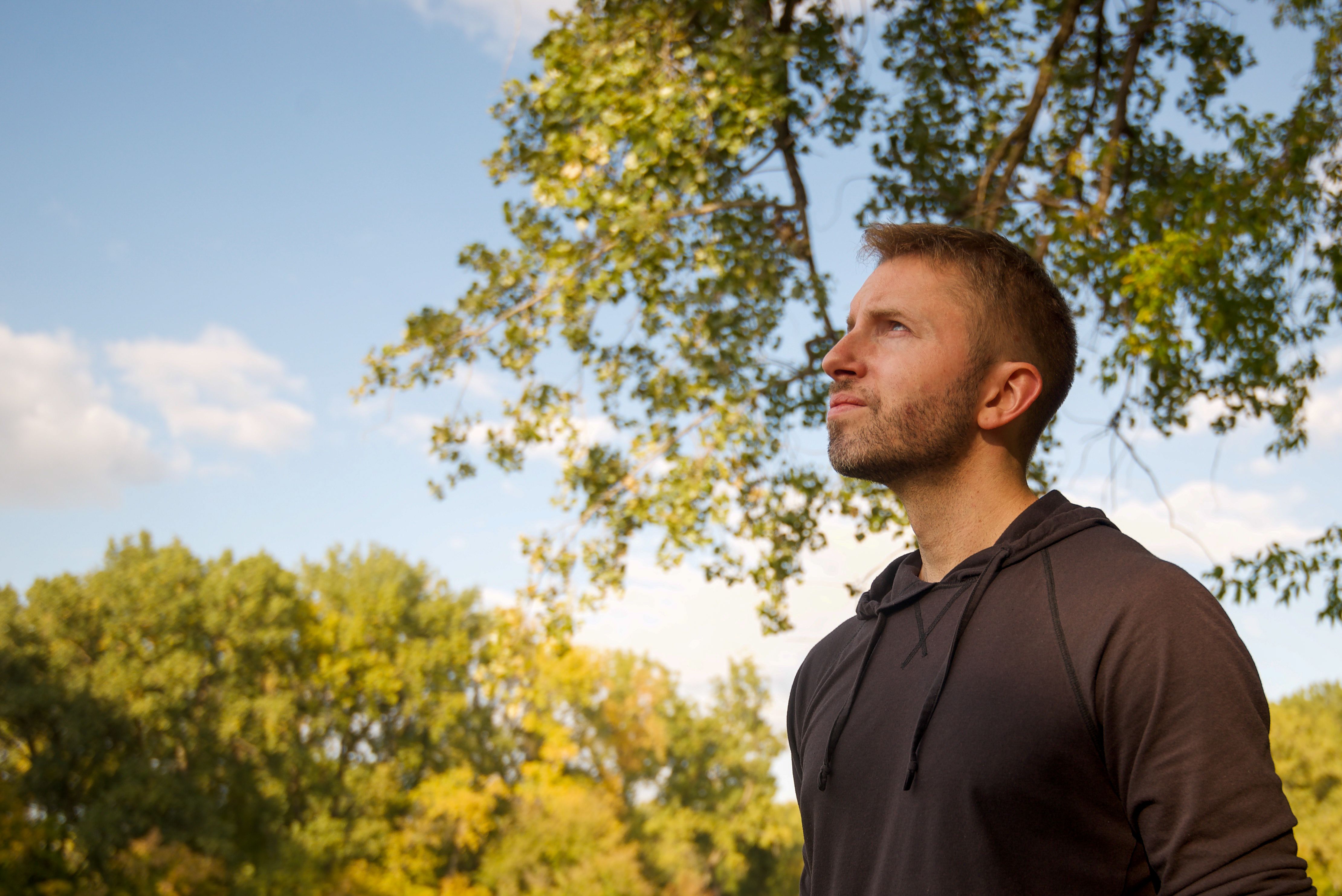 Man looking up with renewed vision and clarity outdoors