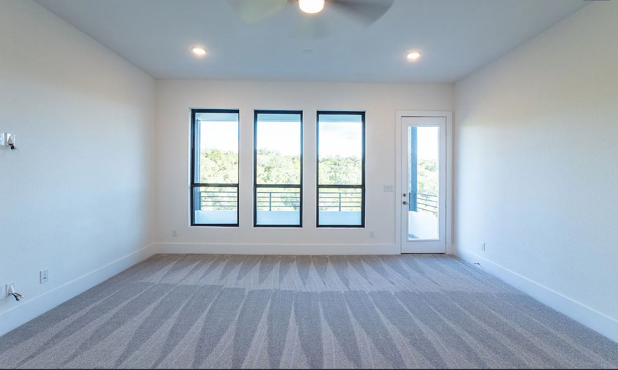 Second bedroom suite with floor-to-ceiling view windows and private balcony walkout