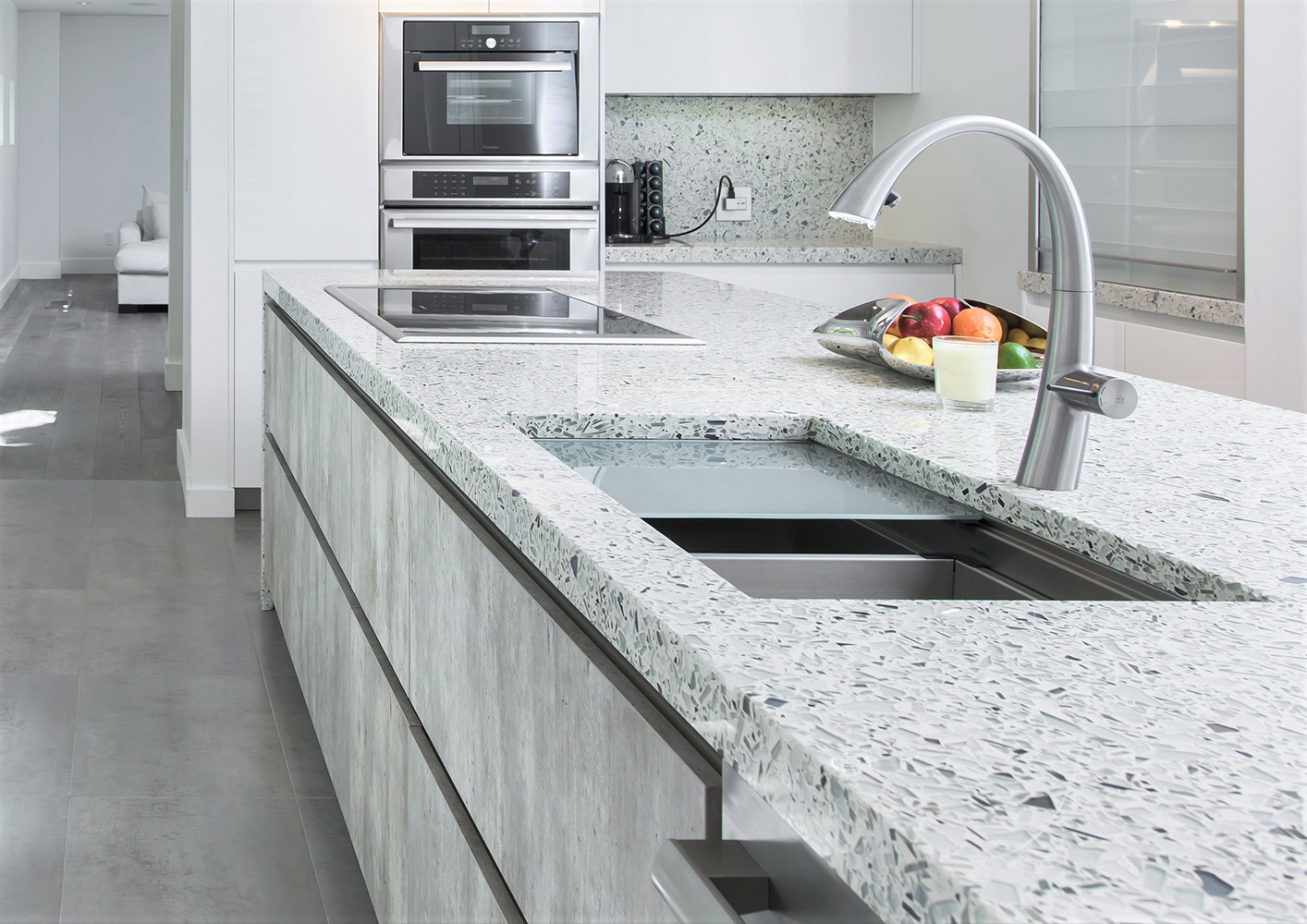 Kitchen island with a white recycled-glass countertop and undermount sink