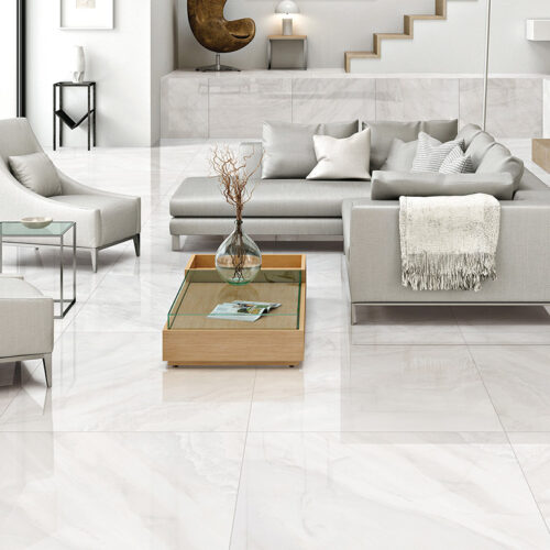 Large-format white marble-look porcelain tile flooring in a modern living room