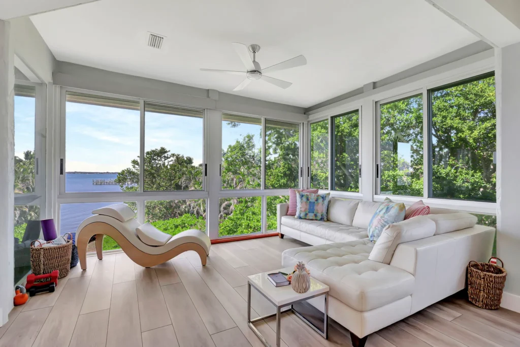 Remodeled sunroom with floor-to-ceiling windows and wood-look tile flooring by Stuart Kitchen Bath and Flooring