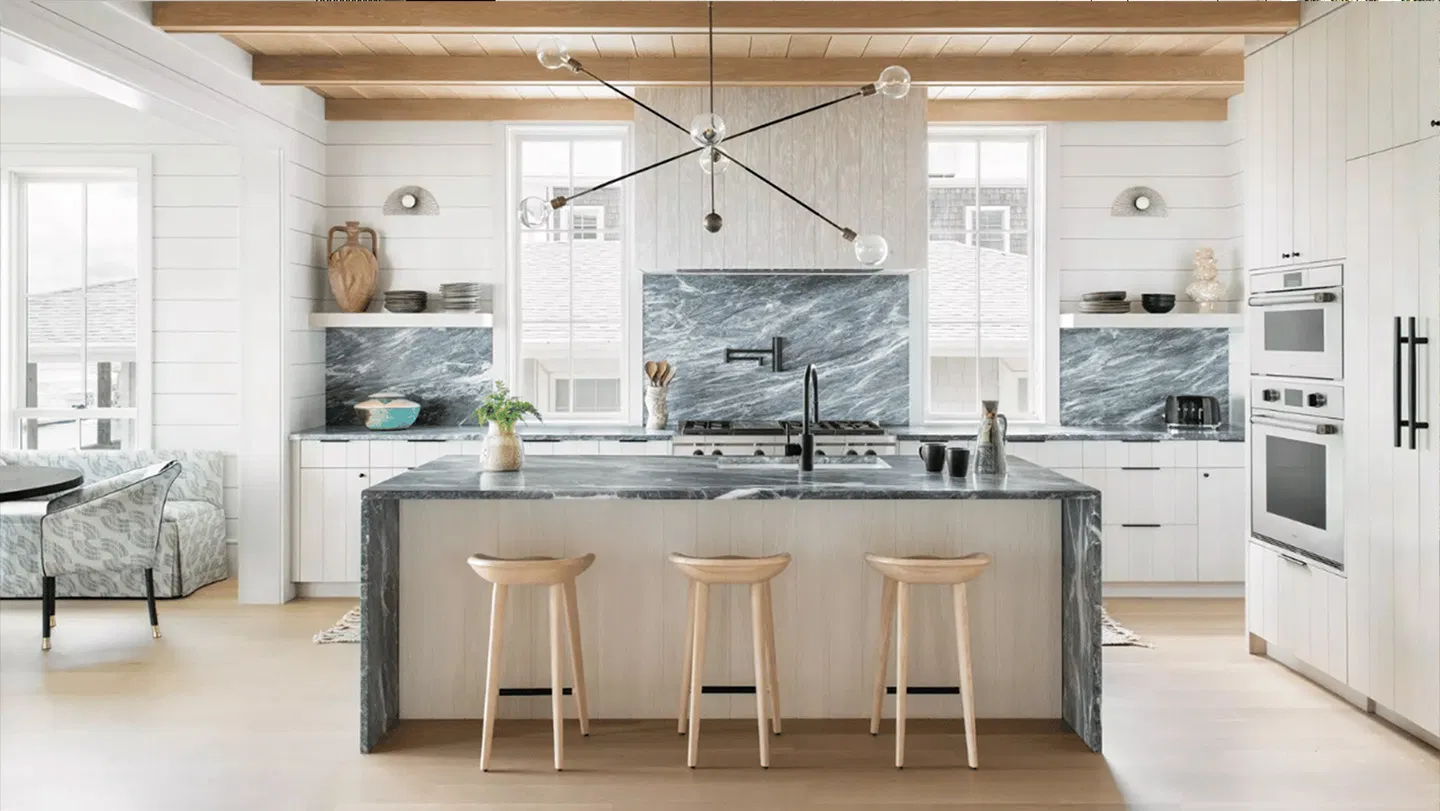 Coastal kitchen remodel with gray marble countertops and a waterfall island by Stuart Kitchen Bath and Flooring