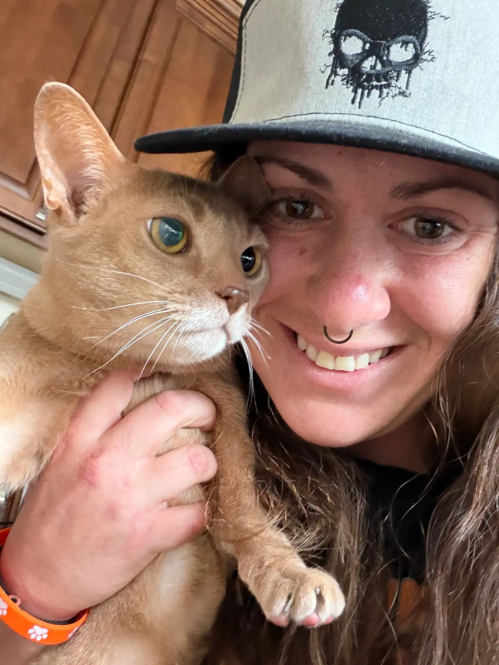Cuddle selfie holding beautiful golden-tan cat indoors — Super Gigi pet sitting and dog walking in Bergen County, NJ
