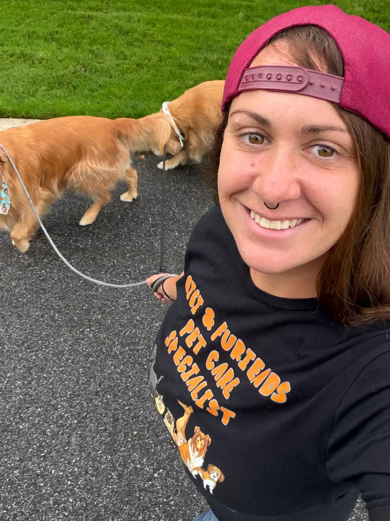 Walking two golden retrievers with backward hat smile — Super Gigi pet sitting and dog walking in Bergen County, NJ