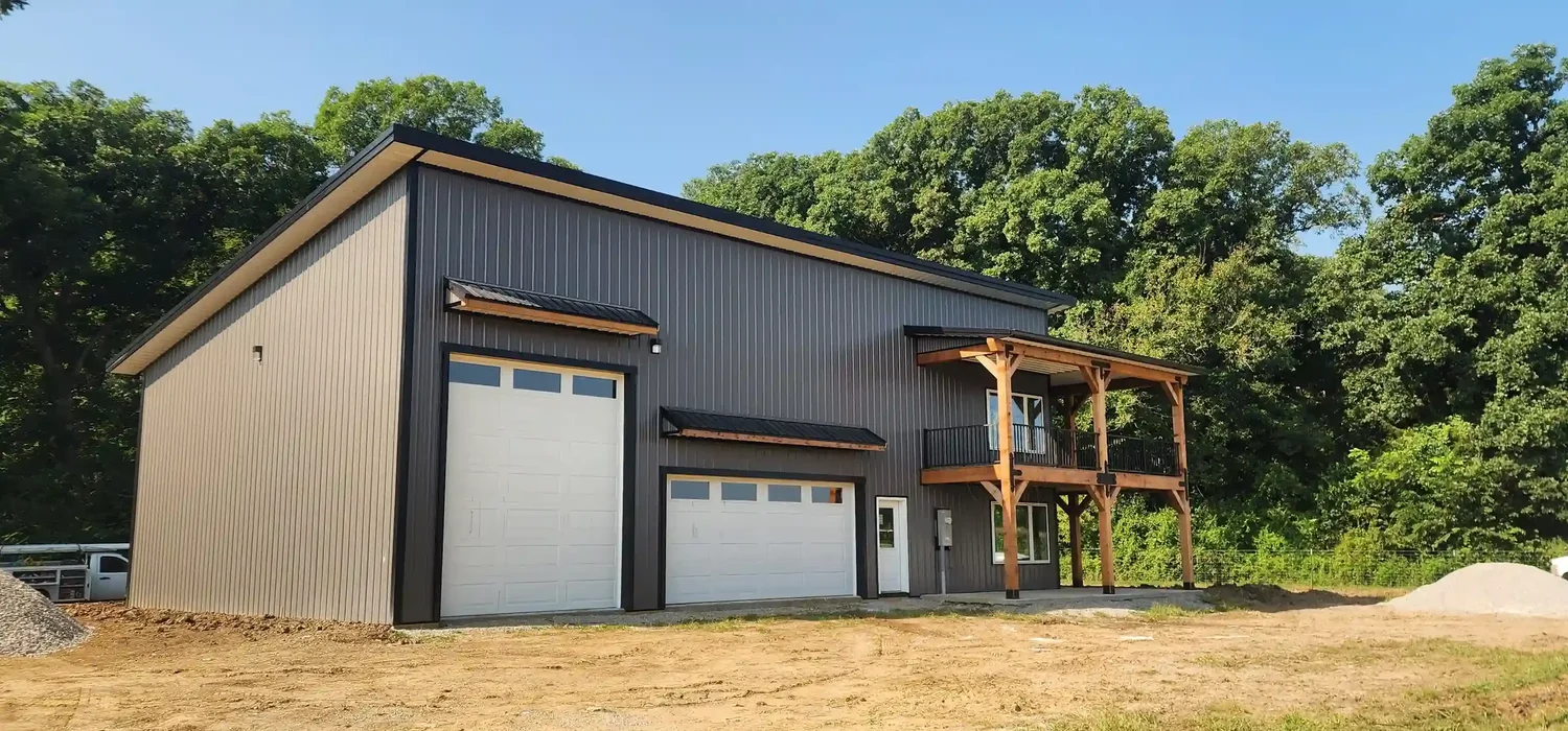 Custom steel frame barndominium with second story deck built by Build N Trust