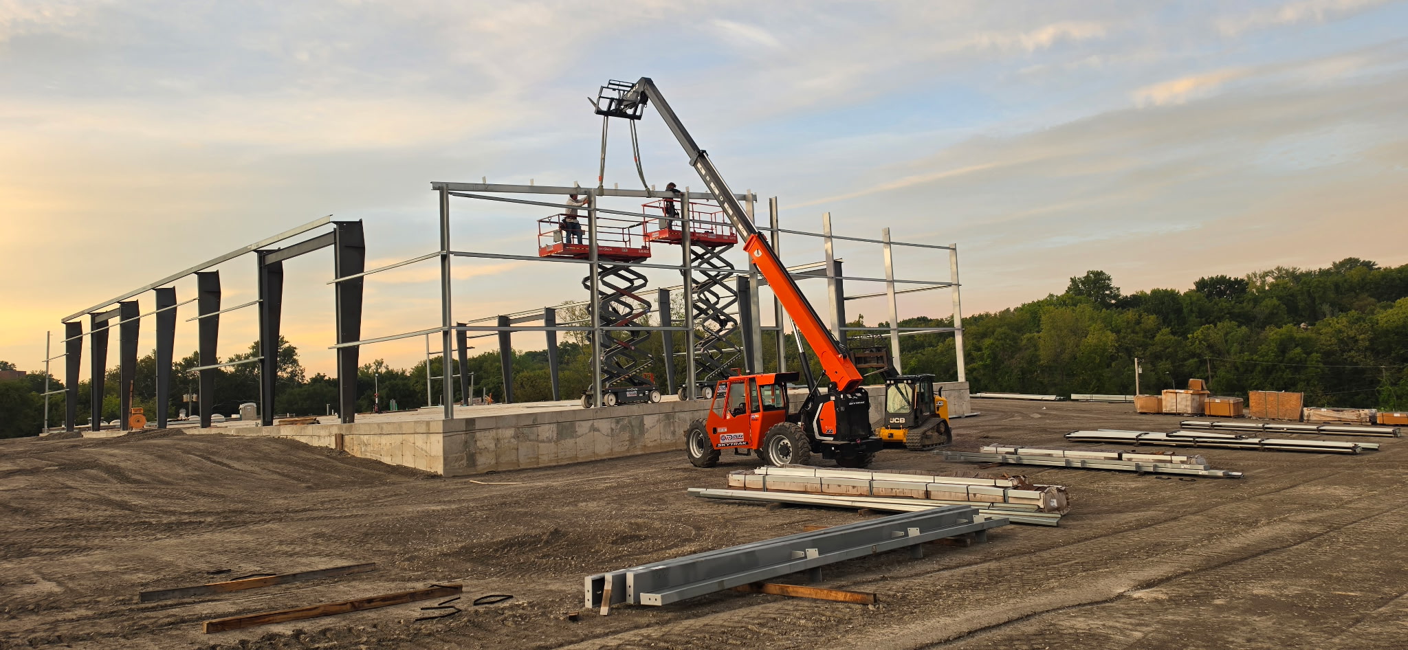 Build N Trust crew erecting structural steel frames with scissor lifts and telehandler in North Missouri