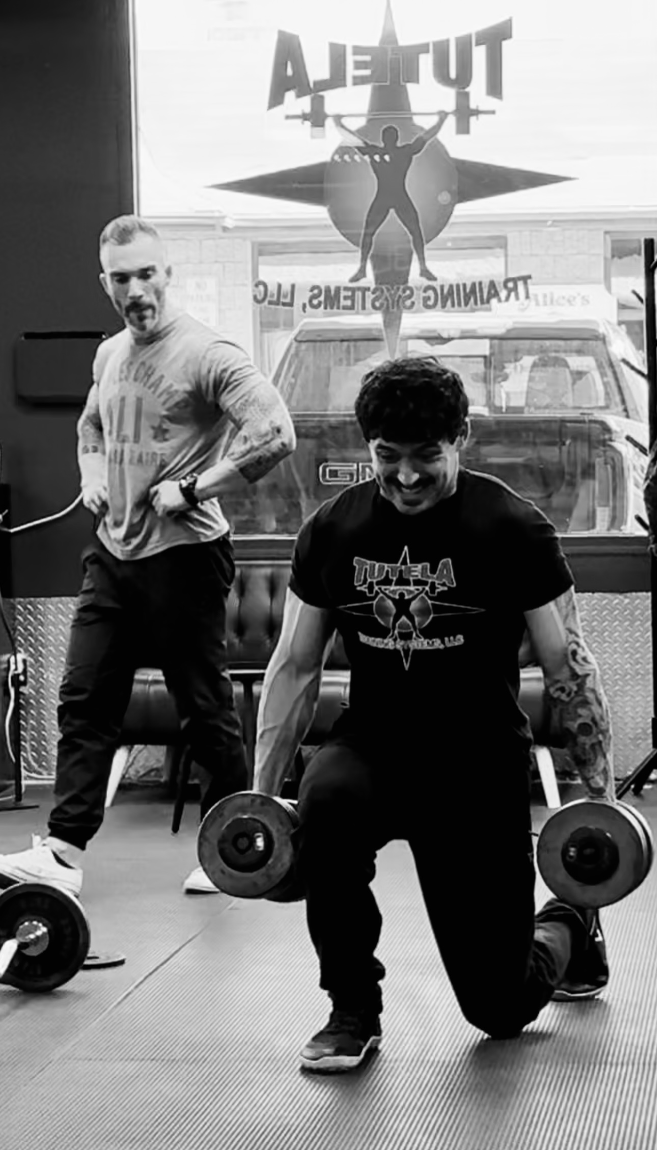 Coach Chris Tutela coaching dumbbell lunges at Tutela Training Systems in Clark, NJ